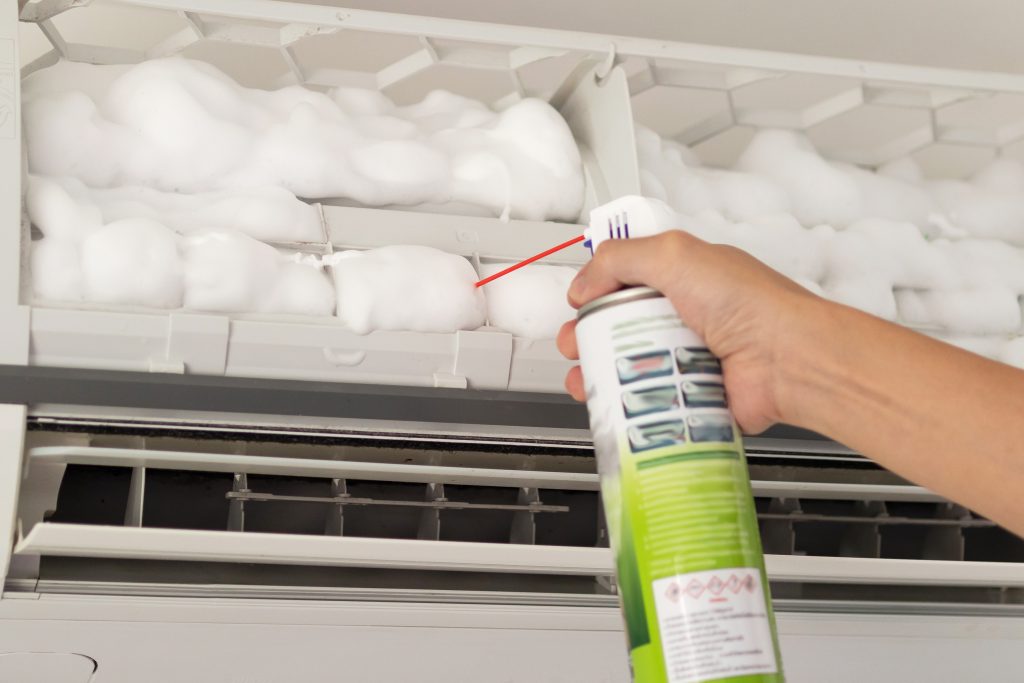 Applying specialized cleaning foam to air conditioner evaporator coils for an at-home chemical wash